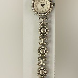 USED Geneva Elite silver-tone flower-pattern bracelet.Toggle close. New battery.